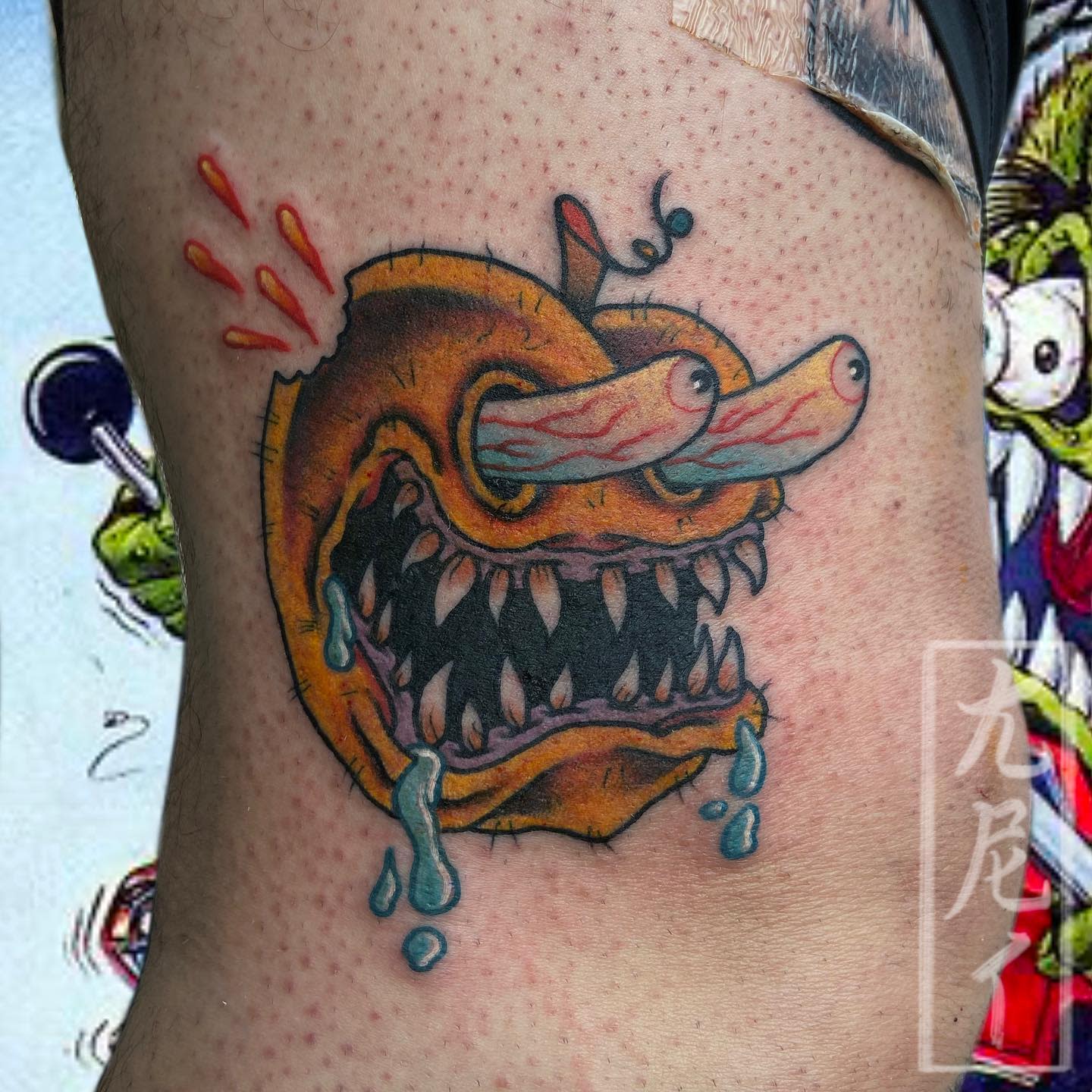 Vibrant, surreal tattoo of a peach with a monstrous face, sharp teeth, and bulging eyes